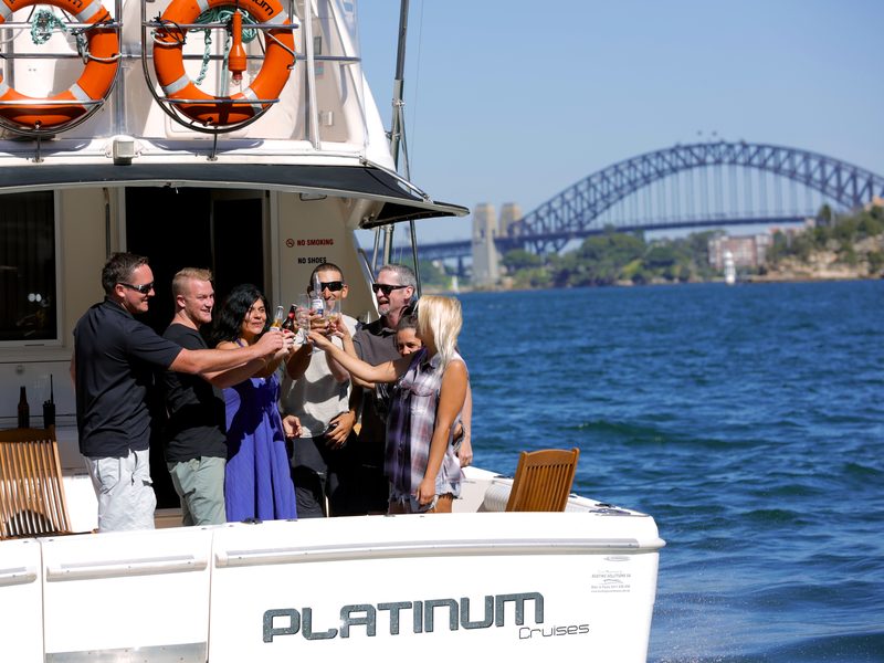 Guests celebrating together aboard a Platinum Cruises charter on Sydney Harbour