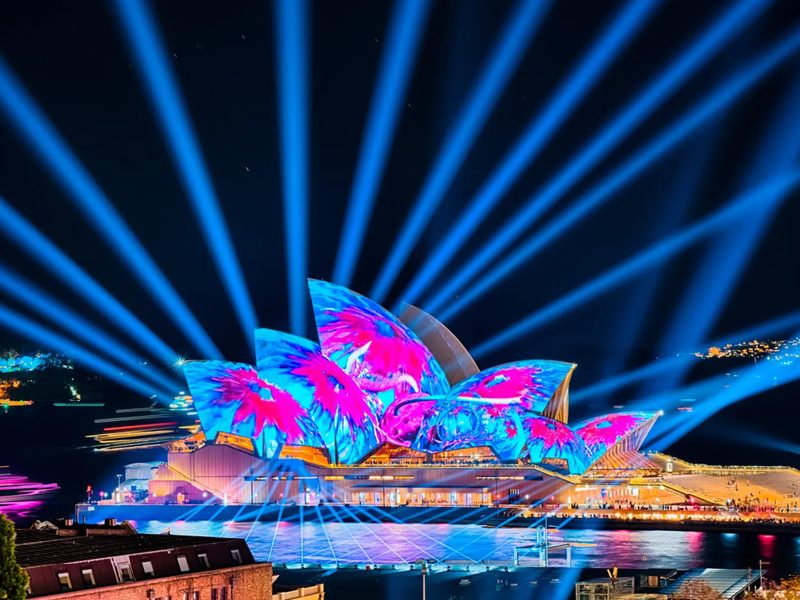 Sydney Opera House illuminated at night, viewed from Platinum Cruises on Sydney Harbour